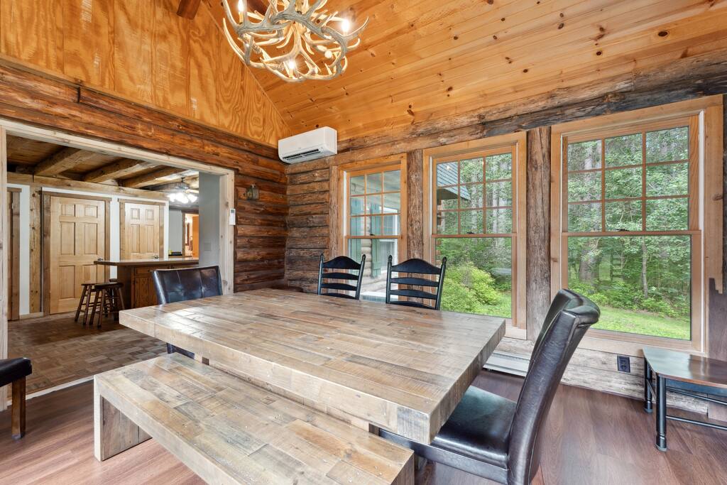 The four-seasons dining room has great taste of cabin decor, featuring a beautiful table with 8 chairs and a bench with more seating in the kitchen. The four-seasons dining room has great taste of cabin decor, featuring a beautiful table with 8 chairs and a bench with more seating in the kitchen. - Eagle Bluff Estate - Mauston