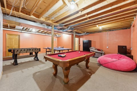 Spacious game room with pool, foosball, ping pong & lounge seating
