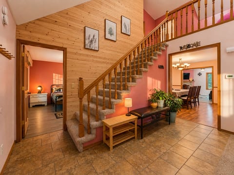 Warm, welcoming entry with grand staircase and open living flow