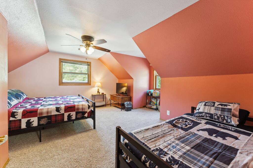 Upstairs bedroom with one king bed, one trundle (two twins), dresser, Roku TV, USB charging ports, hangers and closet, pack n' play, coloring books, and baby toys Upstairs bedroom with one king bed, one trundle (two twins), dresser, Roku TV, USB charging ports, hangers and closet, pack n' play, coloring books, and baby toys - Bear Cove Escape - Lyndon Station