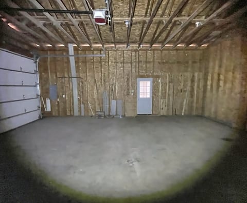 Spacious unfinished garage with ample room for parking and storage
