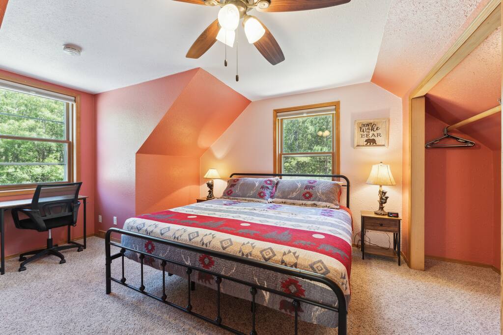 Upstairs bedroom with a king bed, work desk, Roku TV, USB charging ports on lights, dresser, closet with hangers Upstairs bedroom with a king bed, work desk, Roku TV, USB charging ports on lights, dresser, closet with hangers - Bear Cove Escape - Lyndon Station