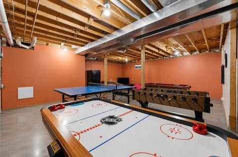 Spacious game room with air hockey, foosball, pool, and ping pong