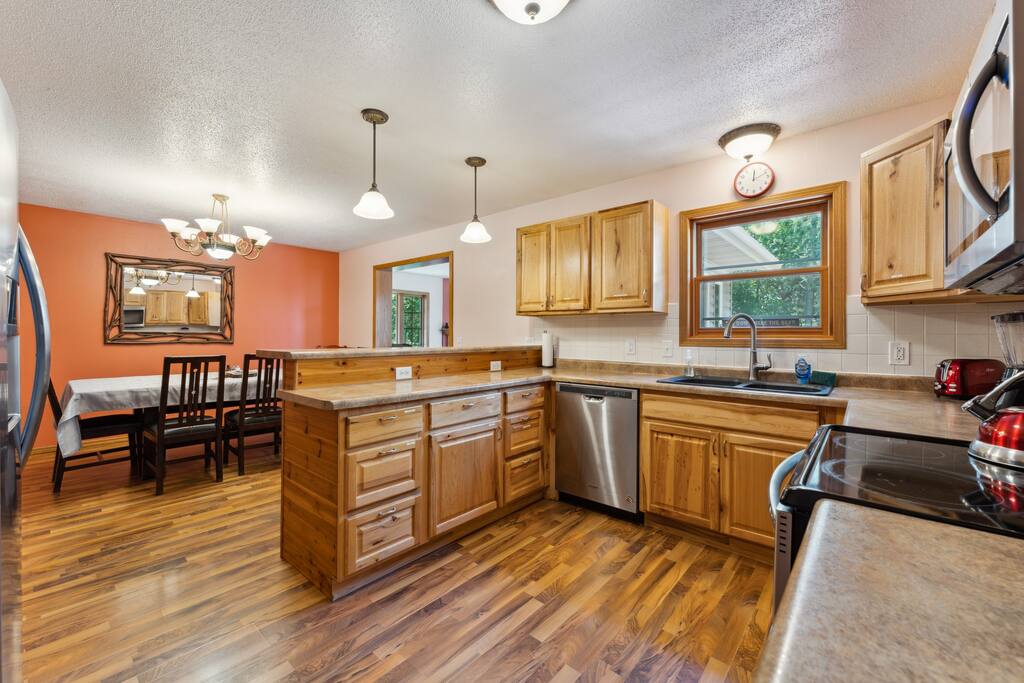 Kitchen featuring stove, microwave, fridge, dishwasher, pots & pans, Keurig, teapot and tea, dinnerware, small spice selection, and much more. Kitchen featuring stove, microwave, fridge, dishwasher, pots & pans, Keurig, teapot and tea, dinnerware, small spice selection, and much more. - Bear Cove Escape - Lyndon Station