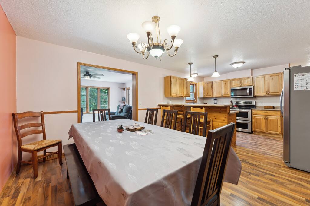 Dining Room: table with 7 chairs, bench that seats 3, 4 more chairs in the garage, plus 3 bar stools at the counter. Dining Room: table with 7 chairs, bench that seats 3, 4 more chairs in the garage, plus 3 bar stools at the counter. - Bear Cove Escape - Lyndon Station