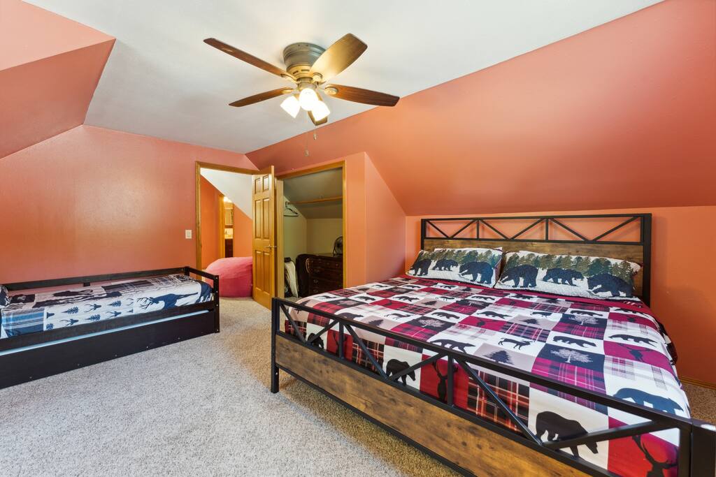 Upstairs bedroom with one king bed, one trundle (two twins), dresser, Roku TV, USB charging ports, hangers and closet, pack n' play, coloring books, and baby toys Upstairs bedroom with one king bed, one trundle (two twins), dresser, Roku TV, USB charging ports, hangers and closet, pack n' play, coloring books, and baby toys - Bear Cove Escape - Lyndon Station