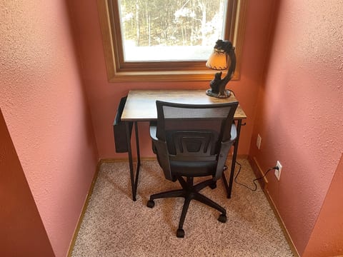 Cozy window-side workspace with forest views and natural light