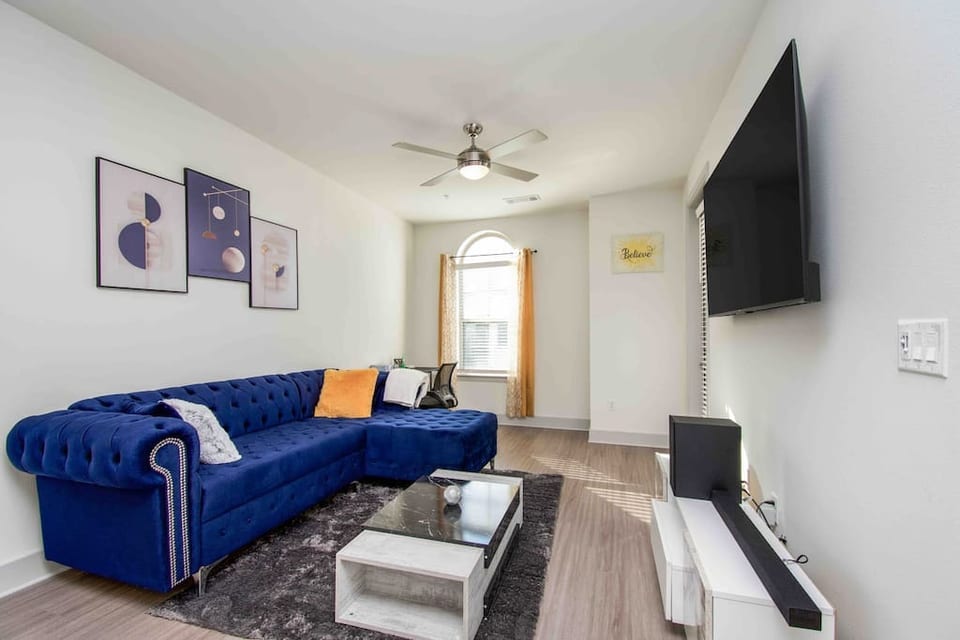 our stylish living room with plush sofa, pillows,and warm ambiance.This space is perfect for relaxation and socializing.Whether you want to curl up with a book,watch your favorite show on the TV, our living-room got you covered.