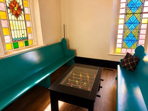 Claim your team and spin the rods — foosball under a cathedral of stained glass is something your friends won't believe until they see it themselves.