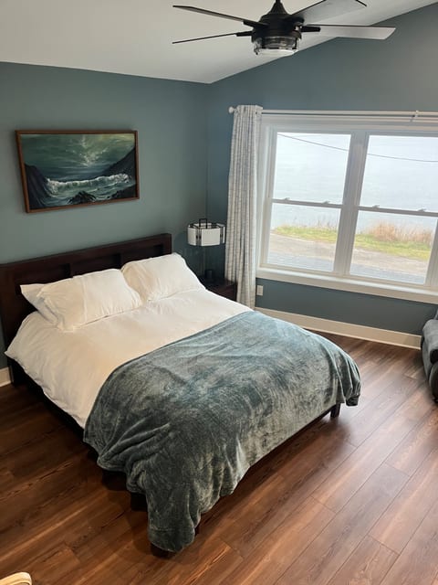 2nd floor master queen bed with lakefront view attached en-suite bathroom with heated floors