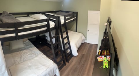 Bunk room with (4) double beds and 55” mounted TV