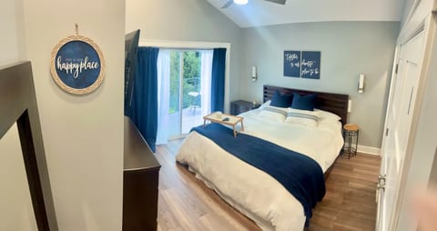 Master bedroom king bed with attached walk out deck facing lake. En-suite bathroom with heated floors