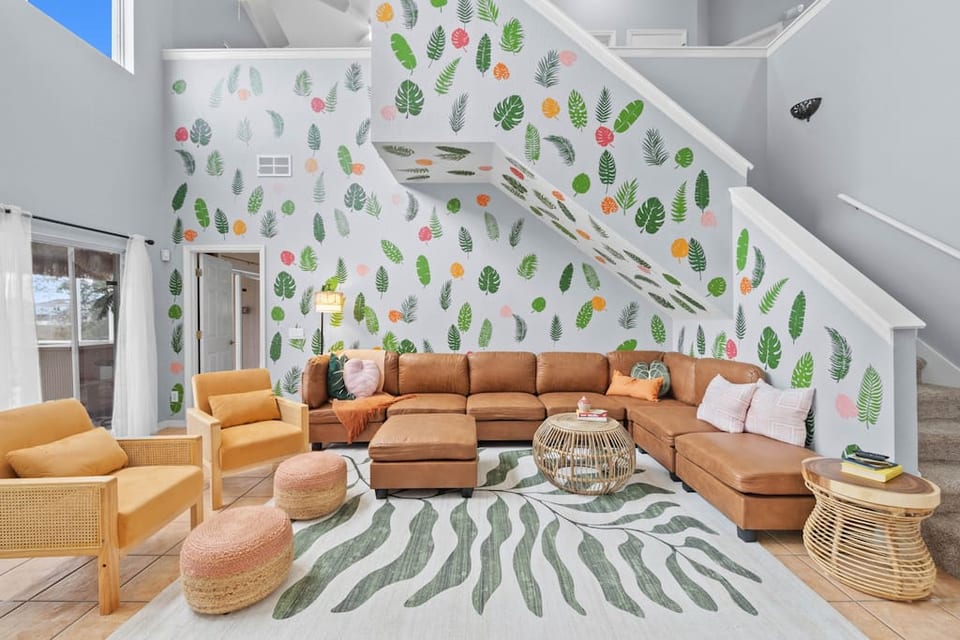 Beneath the loft stairs, a lavish living room beckons with sumptuous couches, creating an elegant and inviting space.