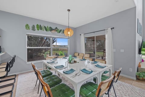 A spacious dining area for 12, complemented by kitchen counter bar seating for 4 and extra chairs for gatherings.
