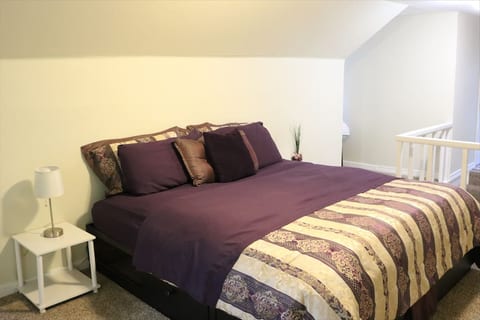 Private upstairs suite with a king-sized bed, lots of extra pillows and blankets, two dormers, a window-seat, a large closet, and its own private bathroom. The spacious, private bathroom is equipped with a shower. A desk is available for laptop use.
