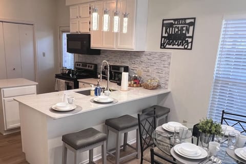 Beautiful open concept kitchen with modern lighting.