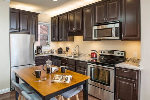 Brand-new kitchen with all stainless steel appliances and dining area