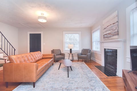 Imagine yourself in this gorgeous living room, spending an evening with family and friends. Need more seating for your crew? Use the green leather desk chair from the workstation behind the couch, or the upholstered chairs in the dining room!