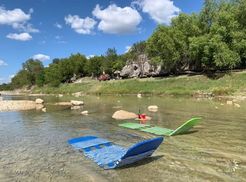 Lay in the river and relax all day directly in front of La Hacienda Rio , pic taken Aug 2020. Chaise lounge chairs provided.