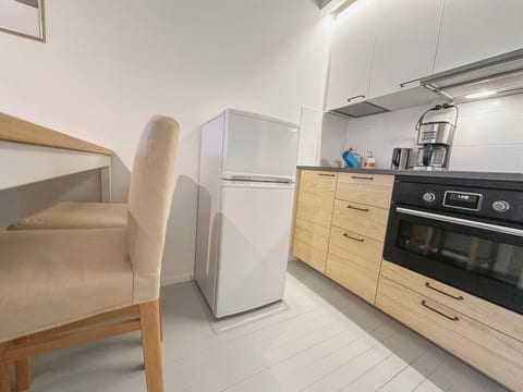 Coffee machine, electronic kettle, induction stove, pots & pans, an oven, a fridge & freezer combo, a dishwasher, and everything else you would expect from a full kitchen.