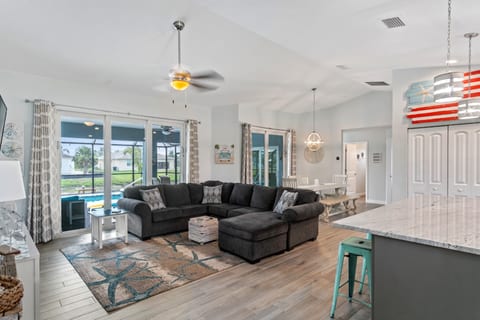 Open concept living area with sliders to the lanai and a 55" smart TV