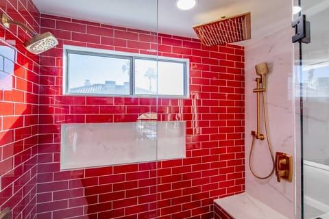 Three shower heads and a sexy bench to sit and shave legs. People love the rain shower head and the relaxing feel.