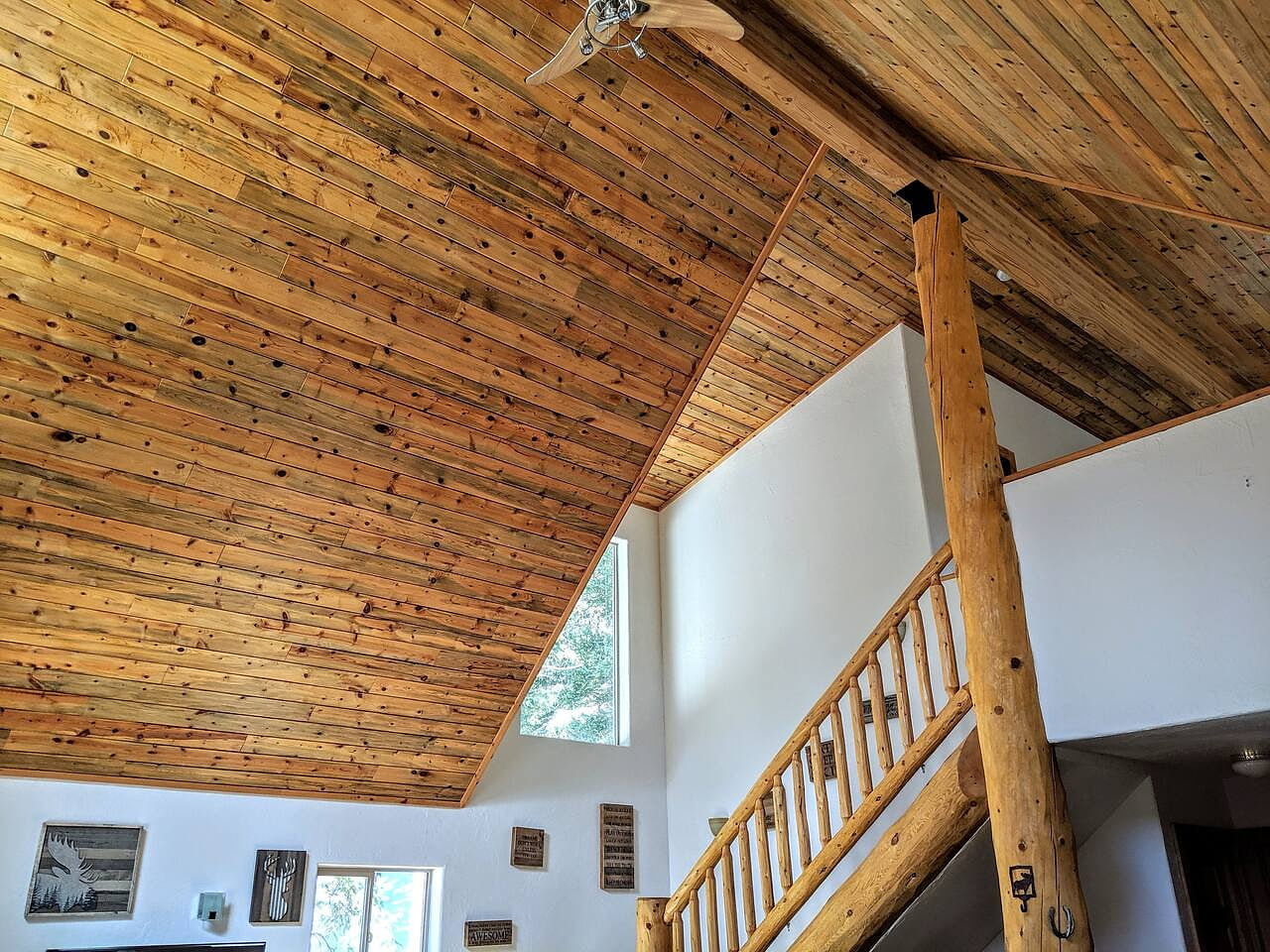 Log pine accents with vaulted beetle kill ceilings for a rustic, yet modern feel. The master loft is accessed via the log pine stairs.