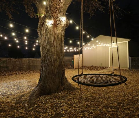 Big fenced in backyard with swing, hot tub, seating area and a seperate dog pen