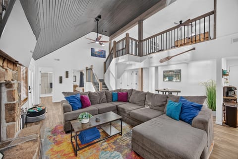Vaulted living room with wood burning fireplace.