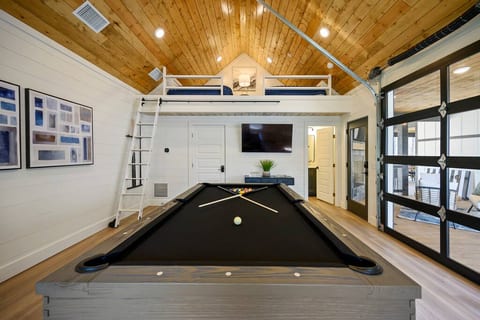 The loft area in the game room can sleep up to 4 & is accessed by the rolling ladder. This room also includes a flat screen TV to enjoy while playing pool.
