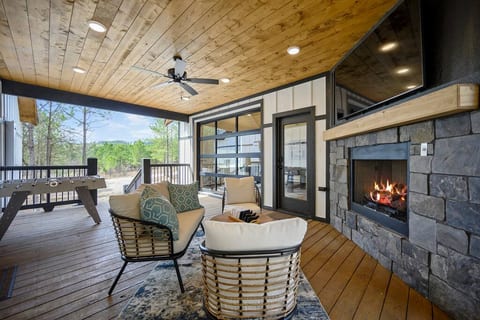 The glass panel garage door can be opened or closed. Grab some bean bags for a game of cornhole, challenge someone to a game of foosball, or open the garage to bring the pool table to the party. The breezeway offers many options for covered outdoor fun, all while looking over the beautiful pines.