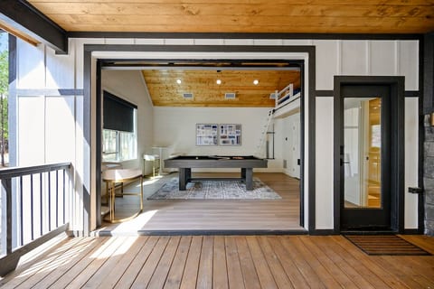 The detached game room has the unique ability to open up to the outdoor breezeway. This room is the namesake of the cabin, welcome to Billiard Breezeway!