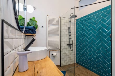 Unique bathroom design w. walk-in shower/ herringbone tile wall