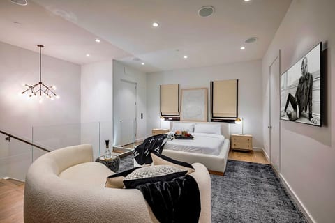 4th floor: Bedroom # 4 is an open space loft w/ a king size bed, en-suite bathroom, seating area, and 65” tv
Optional: 5th queen size rollaway bed per request
Sliding glass doors open to an expansive rooftop terrace