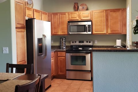 Kitchen fully stocked with dishes, cookware, and small appliances