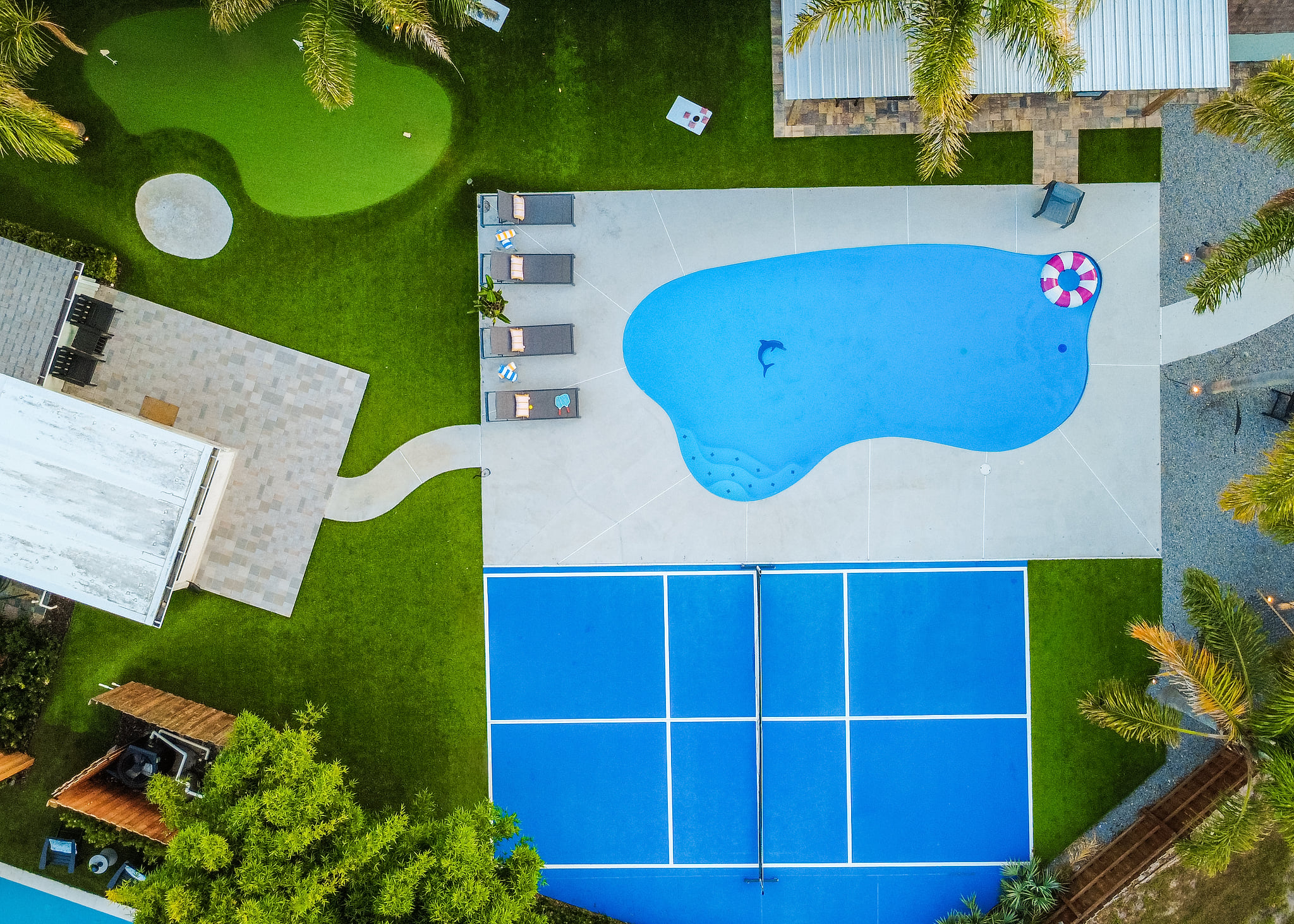 Bird's-eye view of your private backyard oasis - pool, pickleball court, putting green and plenty of room to play