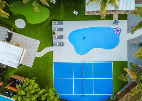 Bird's-eye view of your private backyard oasis - pool, pickleball court, putting green and plenty of room to play