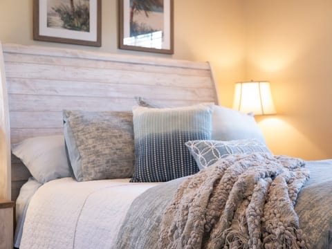 Plush bedding and soft coastal tones for a restful night’s sleep