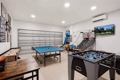 Something for everyone—ping pong, foosball, shuffleboard, arcade basketball, and a TV all in one game room.