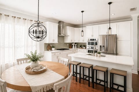 Bright, open kitchen and dining space designed for gathering. Enjoy casual island seating and a cozy dining table perfect for family meals or morning coffee before the beach.