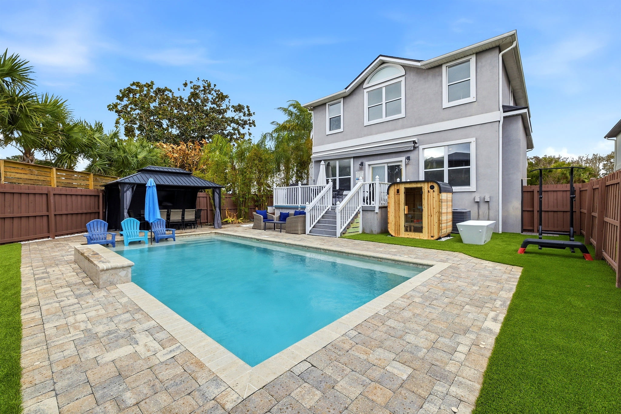 Spacious backyard retreat featuring a private pool, shaded pergola lounge, brand new sauna, cold plunge, and putting green — designed for relaxing and entertaining.