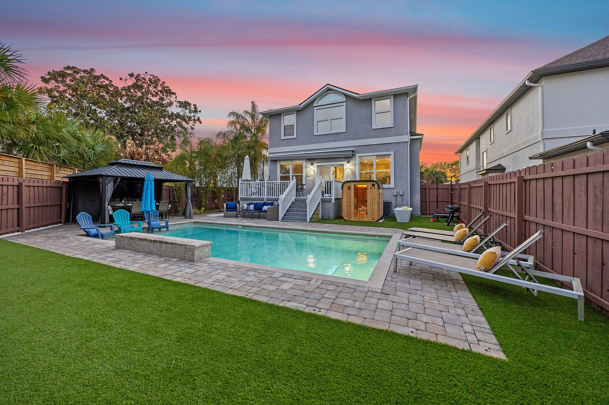 Resort-style backyard made for gathering — private heated pool, lounge seating, and space to unwind after a day at the beach