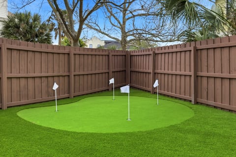 Practice your short game on the brand new backyard putting green — perfect for friendly competition and outdoor fun.