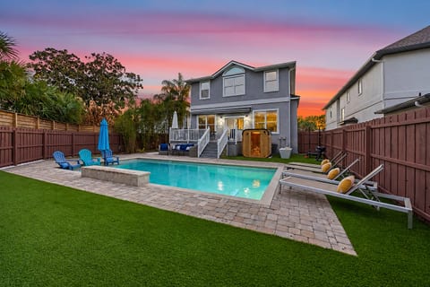 Resort-style backyard made for gathering — private heated pool, lounge seating, and space to unwind after a day at the beach