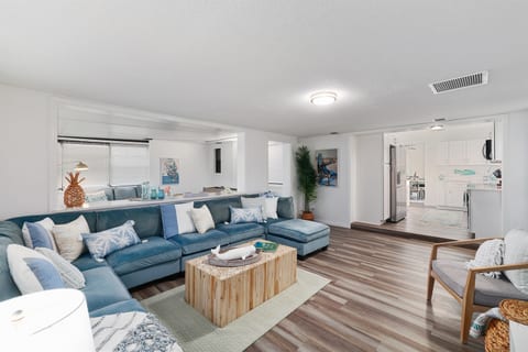 Living room open to kitchen and Florida sunroom
