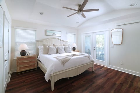 Spacious primary suite with comfortable king bed and natural light. A bright and peaceful place to recharge after a day at the beach