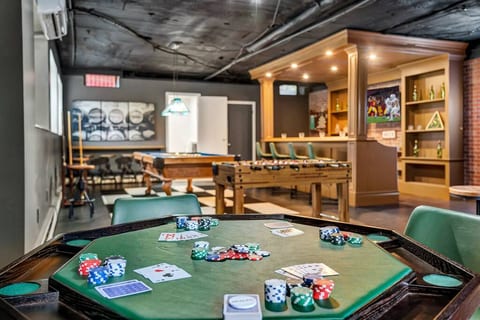 Custom bar and game room with arcade games, pool table, foosball table, 60-inch TV, Bluetooth jukebox, poker table, minifridge, stainless steel ice maker, and tons of seating. This the 2nd basement within this home and this game room is all yours.