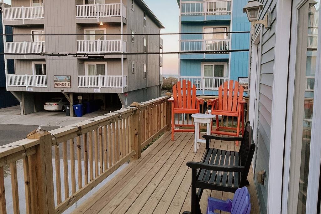 A beautifully rebuilt deck where you can sit on the handmade orange captains chairs or lounge on the glider. Relax and enjoy. - Seahorse Paddock, Ocean View, Pool, Near Boardwalk - Carolina Beach