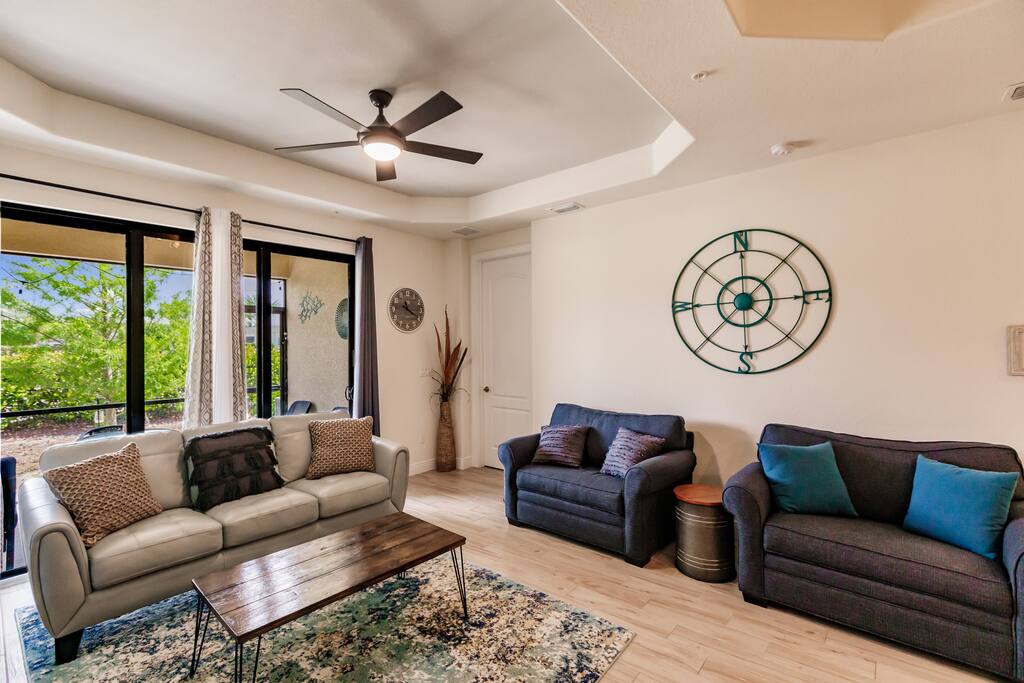 This is the living room of a luxurious first-floor condo, equipped with two pull-out sofa chairs and a 55" smart TV.  Did we mention you can walk to Prime 239 from this condo!