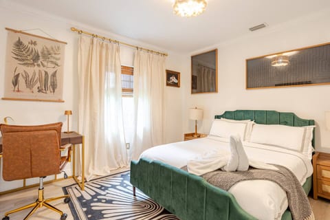 Guest Room Featuring a Queen bed, smart TV & dedicated workspace  